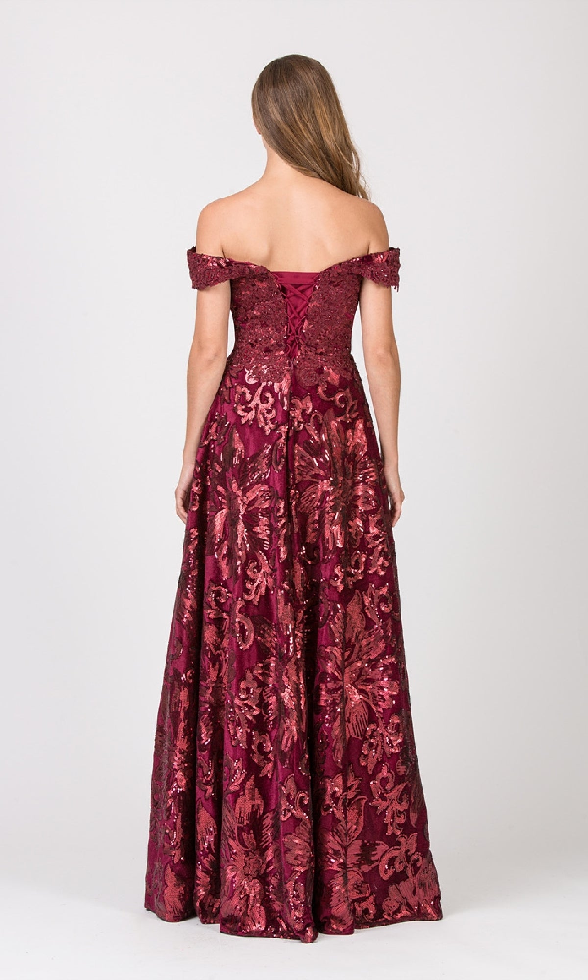 Woman in the Eureka 6733 long formal dress, featuring an off-the-shoulder design, embellished bodice, and floor-length burgundy floral patterns, stands with her back to the camera against a plain light background.